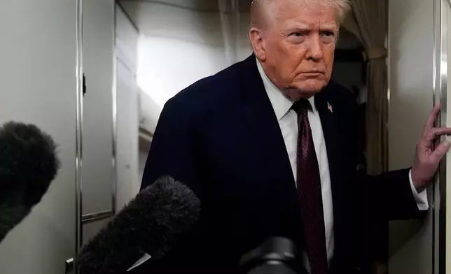 President Donald Trump speaks to reporters while in flight on Air Force One to Joint Base Andrews, Md., Sunday, Jan. 11, 2026. (AP Photo/Julia Demaree Nikhinson)