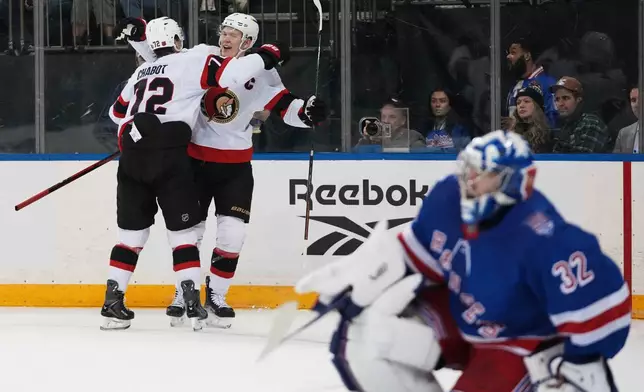 Ottawa Senators' Brady Tkachuk, center, celebrates with teammate Thomas Chabot, left, after scoring a goal as New York Rangers goaltender Jonathan Quick (32) looks away during the first period of an NHL hockey game Wednesday, Jan. 14, 2026, in New York. (AP Photo/Frank Franklin II)