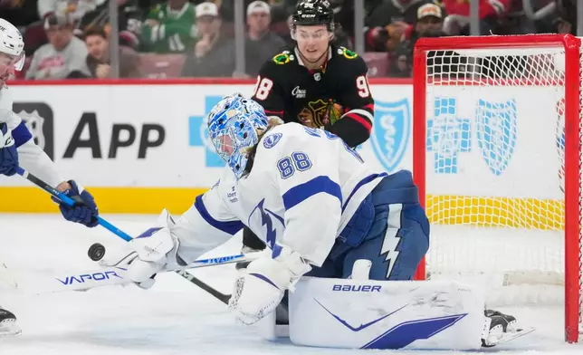 Tampa Bay Lightning goaltender Andrei Vasilevskiy (88) makes a save on the Chicago Blackhawks during the second period of an NHL hockey game Friday, Jan. 23, 2026, in Chicago. (AP Photo/Erin Hooley)