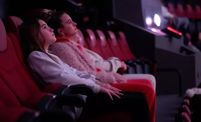 Audience members watch "Ohio: Wild at Heart" that features the state's top-rated park system to highlight wildlife conservation efforts and the restorative power of outdoor recreation at the Robert D. Lindner Family OMNIMAX Theater at the Cincinnati Union Terminal, Tuesday, Dec. 30, 2025, in Cincinnati. (AP Photo/Carolyn Kaster)