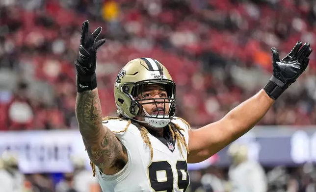 New Orleans Saints defensive end Chase Young (99) celebrates a turnover in the first half of an NFL football game against the Atlanta Falcons, Sunday, Jan. 4, 2026, in Atlanta. (AP Photo/Brynn Anderson)