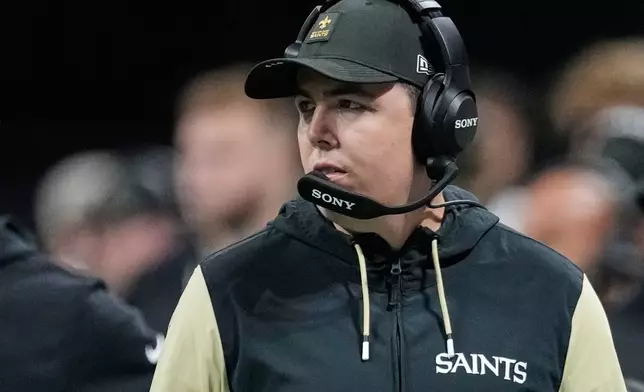 New Orleans Saints head coach Kellen Moore walks on the sideline in the first half of an NFL football game against the Atlanta Falcons, Sunday, Jan. 4, 2026, in Atlanta. (AP Photo/Brynn Anderson)