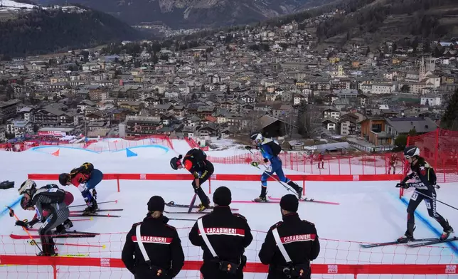 FILE - Athletes compete during the women's mixed relay race at the Ski Mountaineering World Cup event in Bormio, Italy, Sunday, Feb. 23, 2025. (AP Photo/Antonio Calanni, File)