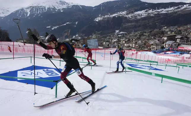 FILE - Athletes compete during the men's sprint race at the Ski Mountaineering World Cup event in Bormio, Italy, Saturday, Feb. 22, 2025. (AP Photo/Antonio Calanni, File)
