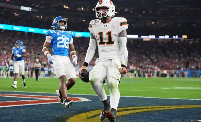 Miami quarterback Carson Beck scores a touchdown during the second half of the Fiesta Bowl NCAA college football playoff semifinal game against Mississippi, Thursday, Jan. 8, 2026, in Glendale, Ariz. (AP Photo/Rick Scuteri)