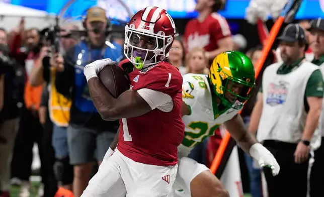 Indiana running back Roman Hemby (1) carries during the first half of the Peach Bowl NCAA college football playoff semifinal against Oregon, Friday, Jan. 9, 2026, in Atlanta. (AP Photo/Mike Stewart)