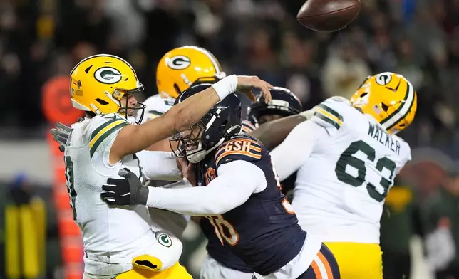 Green Bay Packers' Jordan Love throws as he is hit by Chicago Bears' Montez Sweat during the second half of an NFL wild-card playoff football game Saturday, Jan. 10, 2026, in Chicago. (AP Photo/Nam Huh)