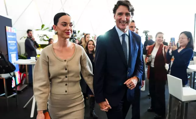 Former Prime Minister Justin Trudeau holds hands with Katy Perry as they leave an event during the World Economic Forum in Davos, Switzerland on Tuesday, Jan. 20, 2026. (Sean Kilpatrick/The Canadian Press via AP)