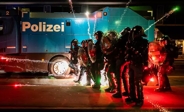 Riot police clash with protesters after a rally against the World Economic Forum in Davos and the visit of US President Donald Trump, on Monday, in Zurich, Switzerland, Jan. 19, 2026. (Michael Buholzer/Keystone via AP)