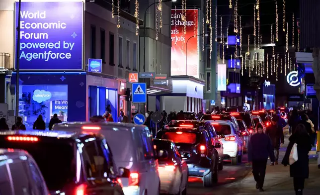 Cars are stuck in a traffic jam on the Promenade street prior to the annual meeting of the World Economic Forum in Davos, Switzerland, Monday, Jan. 19, 2026. (Laurent Gillieron/Keystone via AP)