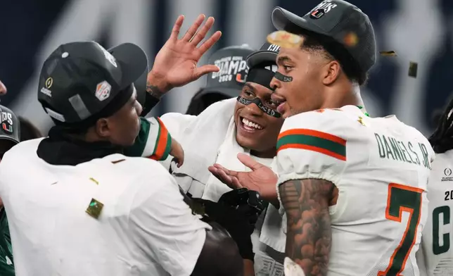 Miami players celebrate after winning the Fiesta Bowl NCAA college football playoff semifinal game against Mississippi, Thursday, Jan. 8, 2026, in Glendale, Ariz. (AP Photo/Ross D. Franklin)