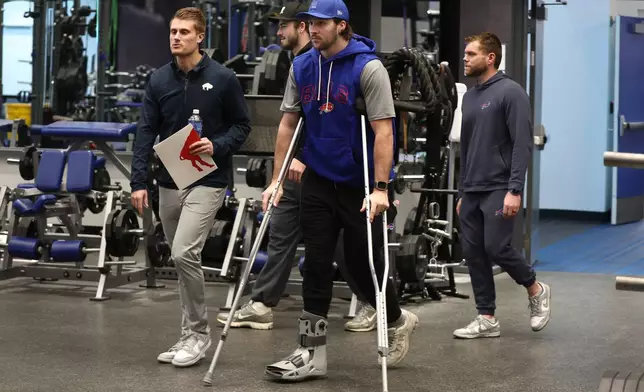 Buffalo Bills quarterback Josh Allen, center, arrives at a press conference to announce Joe Brady as the new head coach in Orchard Park, N.Y., Thursday, Jan. 29, 2026. (AP Photo/Jeffrey T. Barnes)