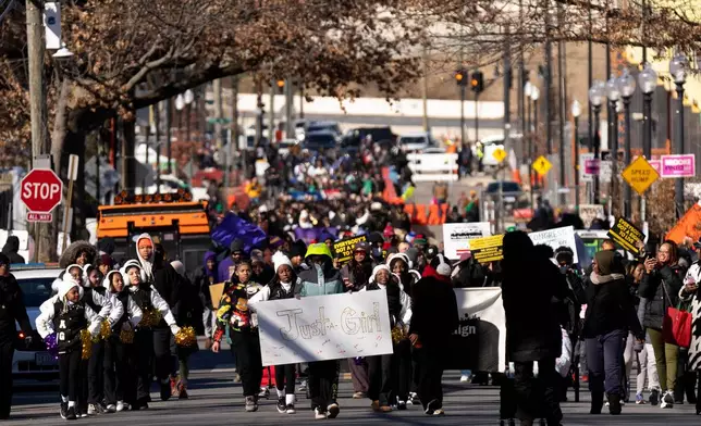 Participants walk during the District of Columbia's annual Martin Luther King Day parade Monday, Jan. 19, 2026, in Washington. (AP Photo/Mark Schiefelbein)