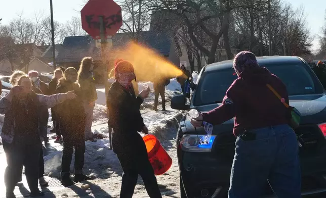 A protester is sprayed with pepper spray by a Federal agent Tuesday, Jan. 13, 2026, in Minneapolis.(AP Photo/Adam Gray)