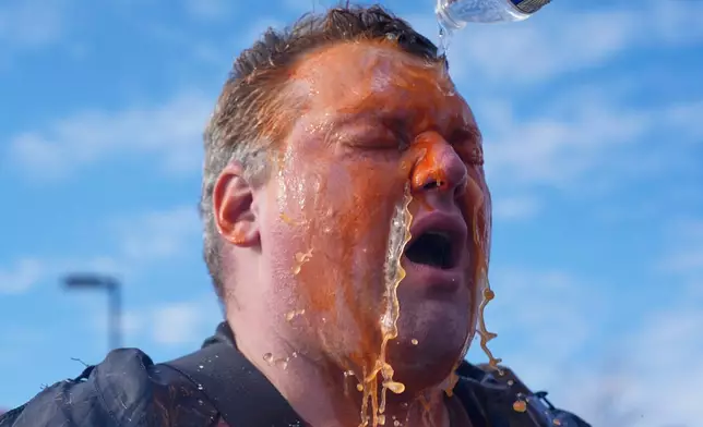 A protester's face is doused in water after he was pepper sprayed outside of the Bishop Whipple Federal Building, Monday, Jan. 12, 2026, in Minneapolis. (AP Photo/Jen Golbeck)