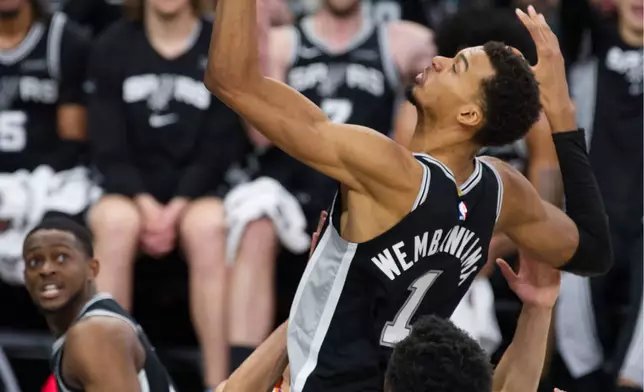 San Antonio Spurs center Victor Wembanyama (1) goes to the basket during the first half of an NBA basketball game against the New York Knicks, Wednesday, Dec. 31, 2025, in San Antonio. (AP Photo/Darren Abate)