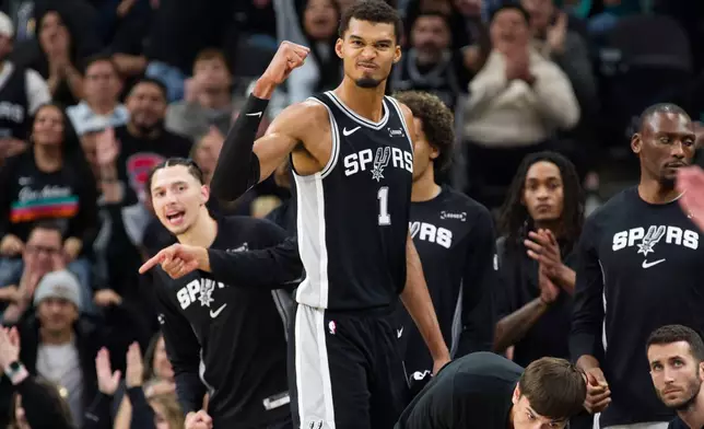 San Antonio Spurs center Victor Wembanyama (1) celebrates a basket during the second half of an NBA basketball game against the New York Knicks, Wednesday, Dec. 31, 2025, in San Antonio. (AP Photo/Darren Abate)