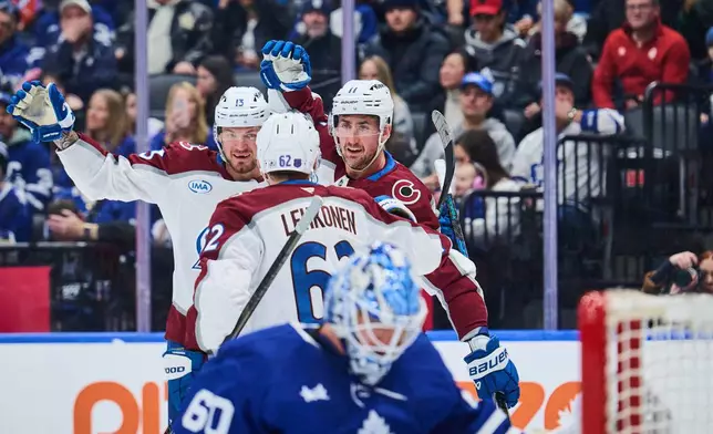 Colorado Avalanche's Brock Nelson (11), right, celebrates with teammates Artturi Lehkonen (62) and Valeri Nichushkin (13) after scoring against the Toronto Maple Leafs during the first period of an NHL hockey game in Toronto, on Sunday, Jan. 25, 2026. (Sammy Kogan/The Canadian Press via AP)