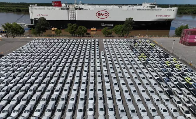 The BYD Changzhou car carrier is docked at Terminal Zarate in the Buenos Aires province of Argentina, Tuesday, Jan. 20, 2026, where hybrid and electric vehicles shipped from China are parked next to the ship. (AP Photo/Victor R. Caivano)