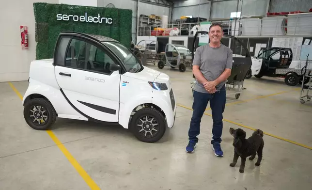 Pablo Naya, the owner of Sero Electric, poses next to one of the company's electric microcars at its factory in Castelar, Argentina, Wednesday, Jan. 21, 2026. (AP Photo/Victor R. Caivano)