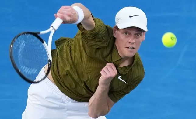 Jannik Sinner of Italy serves to his compatriot Luciano Darderi during their fourth round match at the Australian Open tennis championship in Melbourne, Australia, Monday, Jan. 26, 2026. (AP Photo/Aaron Favila)