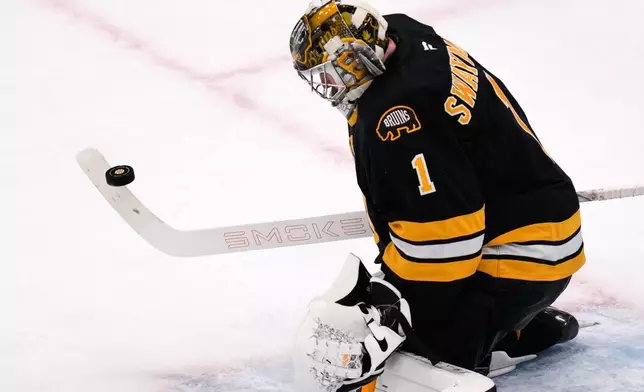 Boston Bruins goaltender Jeremy Swayman makes a stick save during the second period of an NHL hockey game against the Detroit Red Wings, Tuesday, Jan. 13, 2026, in Boston. (AP Photo/Charles Krupa)