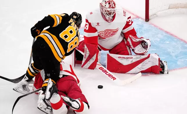 Detroit Red Wings goaltender Cam Talbot makes a save on a shot by Boston Bruins right wing David Pastrnak (88) during the third period of an NHL hockey game, Tuesday, Jan. 13, 2026, in Boston. (AP Photo/Charles Krupa)