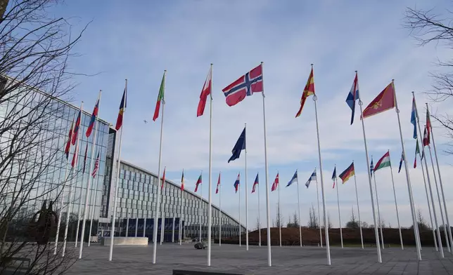 Flags flap in the wind outside NATO headquarters in Brussels, Monday, Jan. 19, 2026. (AP Photo/Virginia Mayo)