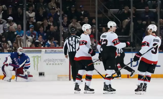 Ottawa Senators' Thomas Chabot (72) celebrates with David Perron (57) and Nick Jensen (3) after scoring a goal during the second period of an NHL hockey game against the New York Rangers Wednesday, Jan. 14, 2026, in New York. (AP Photo/Frank Franklin II)