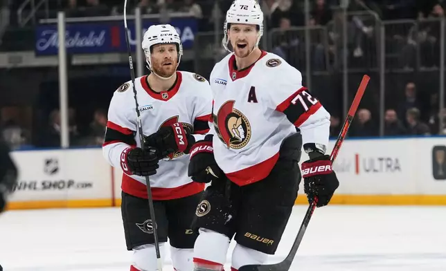 Ottawa Senators' Nick Jensen, left, celebrates with Thomas Chabot (72) after scoring a goal during the first period of an NHL hockey game Wednesday, Jan. 14, 2026, in New York. (AP Photo/Frank Franklin II)