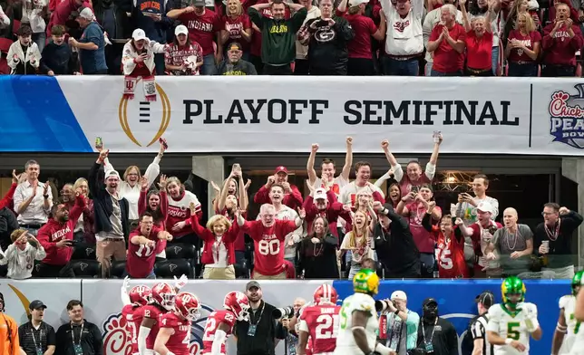Indiana fans cheer after an interception was returned for a touchdown during the first half of the Peach Bowl NCAA college football playoff semifinal against Oregon, Friday, Jan. 9, 2026, in Atlanta. (AP Photo/Brynn Anderson)