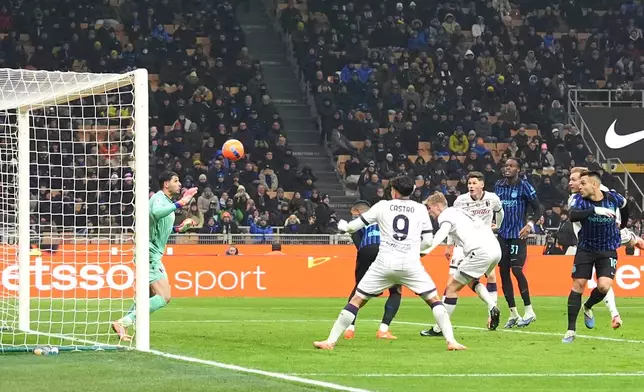 Inter Milan's Lautaro Martinez, right, scores his side's second goal during the Italian Serie A soccer match between Inter and Bologna in Milan, Italy, Sunday, Jan. 4, 2026. (Spada/LaPresse via AP)