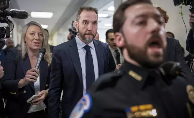 Former Justice Department special counsel Jack Smith, center, is escorted by Capitol Police through a crush of reporters as he arrives to testify before the House Judiciary Committee about his investigations into President Donald Trump, Thursday, Jan. 22, 2026 at the Capitol in Washington. (AP Photo/J. Scott Applewhite)