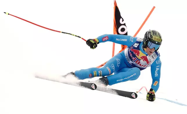 Italy's Giovanni Franzoni speeds down the course during a men's alpine ski World Cup downhill, in Kitzbuehel, Austria, Saturday, Jan. 24, 2026. (AP Photo/Gabriele Facciotti)