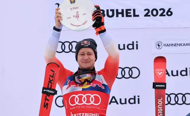 Switzerland's Marco Odermatt celebrates his second place in a men's alpine ski World Cup downhill, in Kitzbuehel, Austria, Saturday, Jan. 24, 2026. (AP Photo/Marco Trovati)
