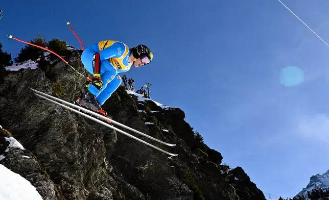 Giovanni Franzoni of Italy takes a jump during the alpine ski, men's World Cup super-G race, in Wengen, Switzerland, Friday, Jan. 16, 2026. (Jean-Christophe Bott/Keystone via AP)