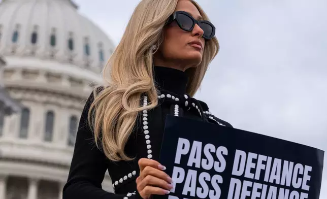 FILE - Paris Hilton poses for pictures following a news conference promoting the passage of the DEFIANCE Act at the Capitol, Thursday, Jan. 22, 2026, in Washington. (AP Photo/Allison Robbert, File)