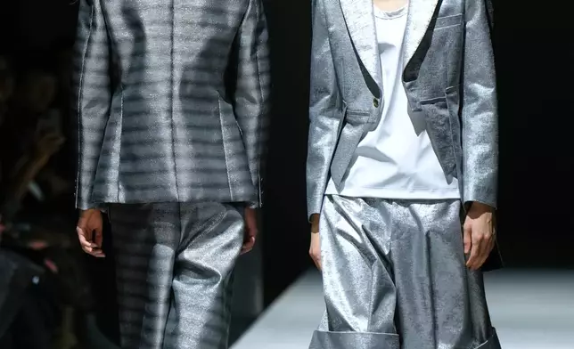 FILE - Models wear creations as part of the Comme des Garcons Fall/Winter 2026-2027 Men's collection presented in Paris, Friday, Jan. 23, 2026. (AP Photo/Aurelien Morissard, File)