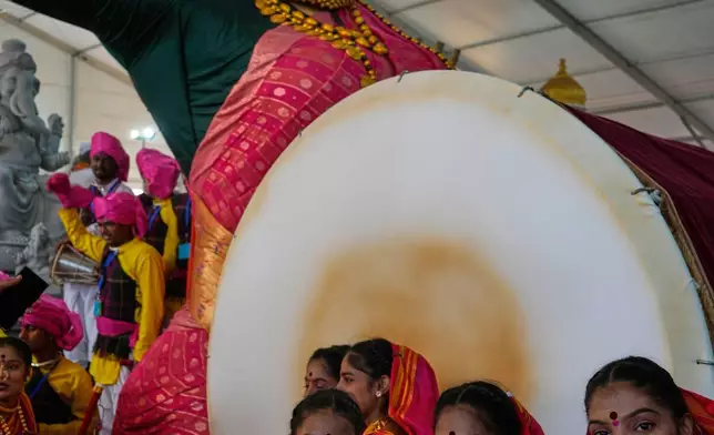 FILE - Folk artist take some rest beside Indian state of Maharashtra tableaux during a press preview ahead of Republic Day celebrations on Jan. 26, in New Delhi, India, Thursday, Jan. 22, 2026. (AP Photo/Manish Swarup, File)