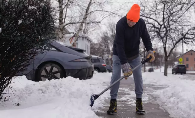 Richard Hill shovels the sidewalk outside his home on Wednesday, Jan. 7, 2026 in Vergennes, Vt. (AP Photo/Amanda Swinhart)