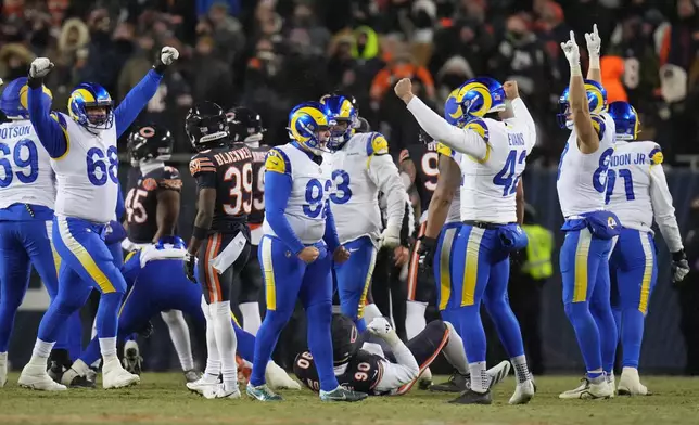 Los Angeles Rams kicker Harrison Mevis, center, reacts with holder Ethan Evans, center right, and teammates after booting a game-winning field goal during overtime of an NFL football divisional playoff game against the Chicago Bears, Sunday, Jan. 18, 2026, in Chicago. (AP Photo/Jeff Roberson)