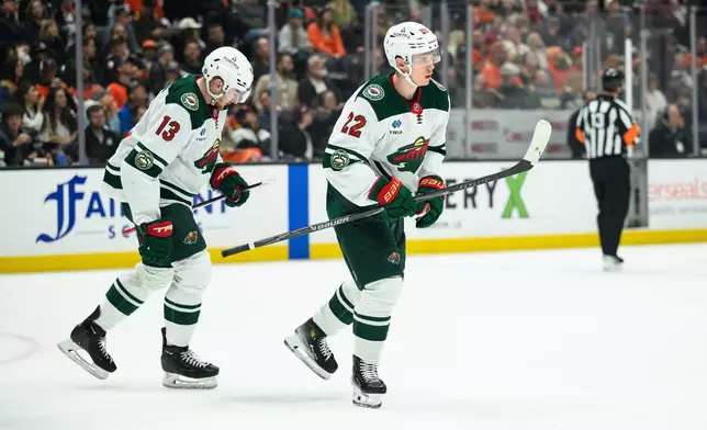 Minnesota Wild right wing Danila Yurov, right, skates off after scoring during the second period of an NHL hockey game against the Anaheim Ducks, Friday, Jan. 2, 2026, in Anaheim, Calif. (AP Photo/William Liang)