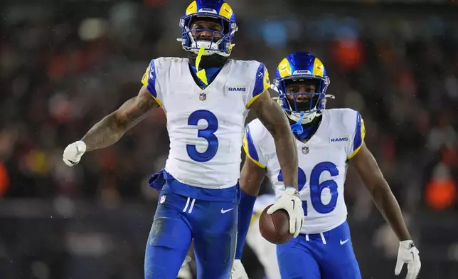Los Angeles Rams safety Kam Curl (3) reacts with safety Kamren Kinchens (26) after intercepting a pass by Chicago Bears quarterback Caleb Williams, not visible, during overtime of an NFL football divisional playoff game Sunday, Jan. 18, 2026, in Chicago. (AP Photo/Jeff Roberson)