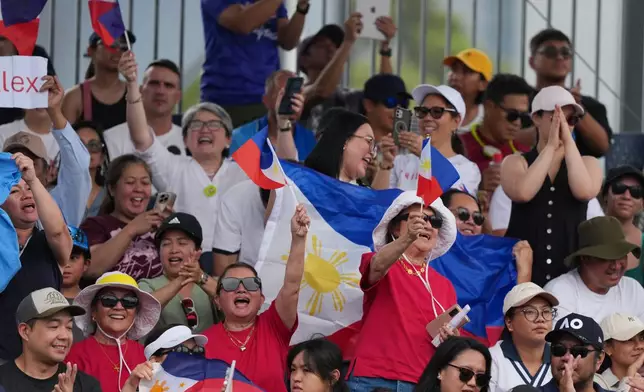 Supporters of Alexandra Eala of the Philippines react during her first round match against Alycia Parks of the U.S. at the Australian Open tennis championship in Melbourne, Australia, Monday, Jan. 19, 2026. (AP Photo/Dar Yasin)