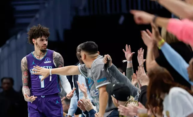 Charlotte Hornets guard LaMelo Ball (1) celebrates with fans after hitting a three-pointer during the first half of an NBA basketball game against the Indiana Pacers in Charlotte, N.C., Thursday, Jan. 8, 2026. (AP Photo/Nell Redmond)