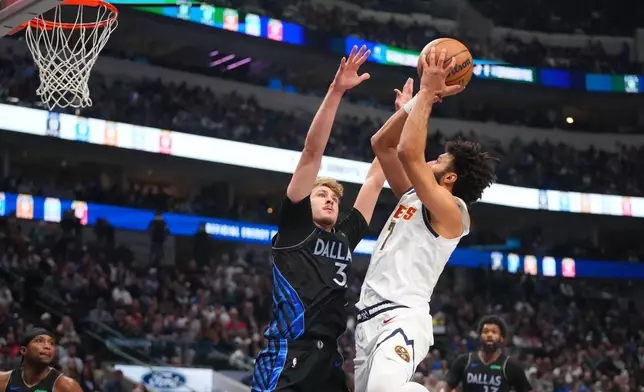 Denver Nuggets guard Jamal Murray, right, goes up for a basket against Dallas Mavericks forward Cooper Flagg during the first half of an NBA basketball game Wednesday, Jan. 14, 2026, in Dallas. (AP Photo/Julio Cortez)
