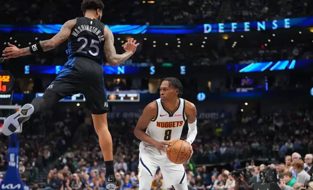 Denver Nuggets guard Peyton Watson (8) avoids the defense of Dallas Mavericks forward P.J. Washington (25) while preparing to take a shot during the first half of an NBA basketball game Wednesday, Jan. 14, 2026, in Dallas. (AP Photo/Julio Cortez)