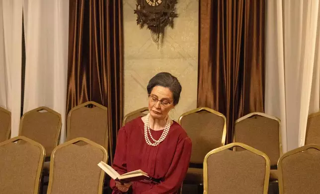 Tamara Masic, an amateur actor, poses for a photograph in an old villa used for theater performances by an independent theater production, in Belgrade, Serbia, Sunday, Jan. 18, 2026. (AP Photo/Marko Drobnjakovic)