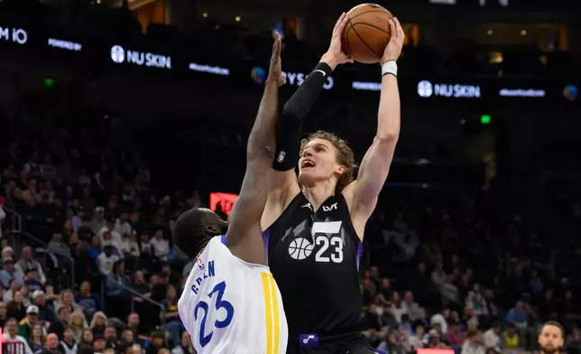 Utah Jazz forward Lauri Markkanen (23) shoots over Golden State Warriors forward Draymond Green (23) during the first half of an NBA basketball game, Wednesday, Jan. 28, 2026, in Salt Lake City. (AP Photo/Tyler Tate)