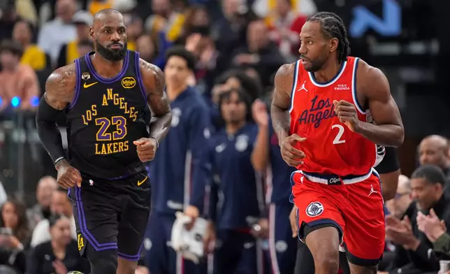 Los Angeles Lakers forward LeBron James, left, and Los Angeles Clippers forward Kawhi Leonard up court during the first half of an NBA basketball game Thursday, Jan. 22, 2026, in Inglewood, Calif. (AP Photo/Mark J. Terrill)